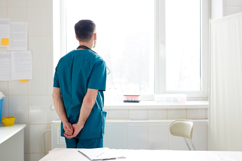 Clinician looking through hospital window